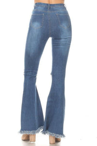Distressed flare denim jeans with frayed hems, perfect for women's fashion and vacation outfits.