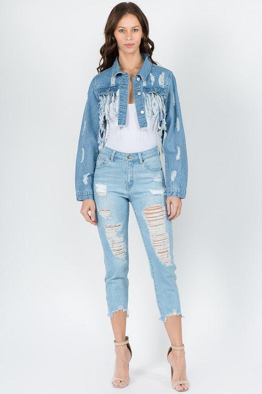Trendy women's denim outfit with distressed jeans, frayed jacket, and heels — perfect for casual or vacation looks.